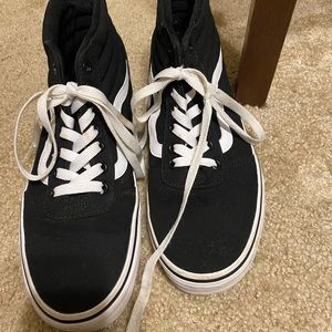 Black and white high top vans